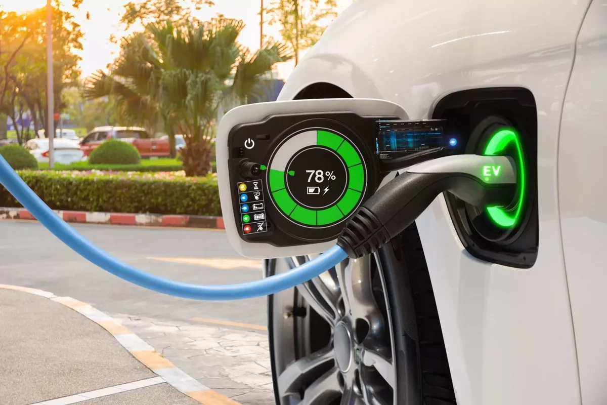 EV fast charging connector being plugged into electric car